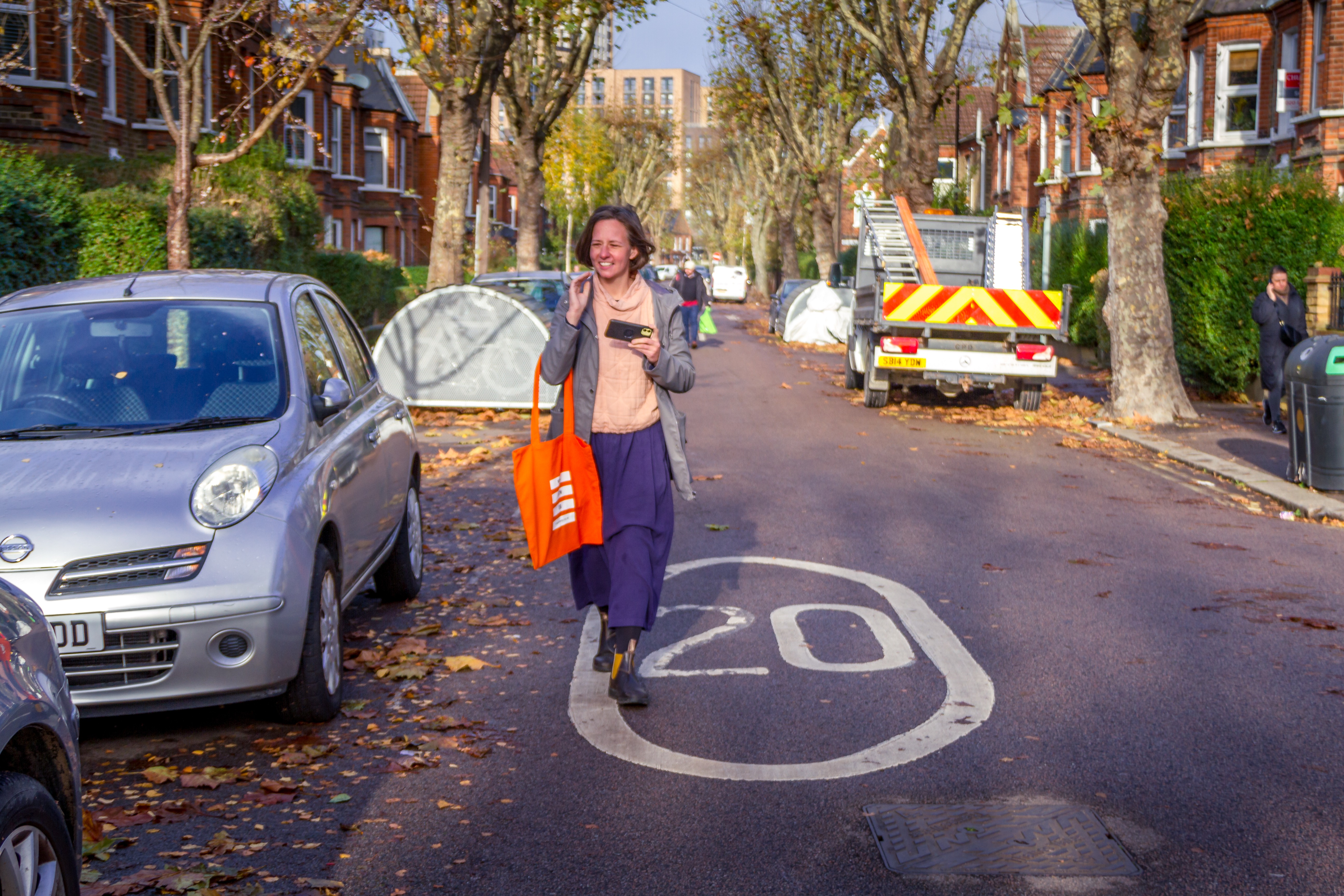 A woman walking down a 20mph street